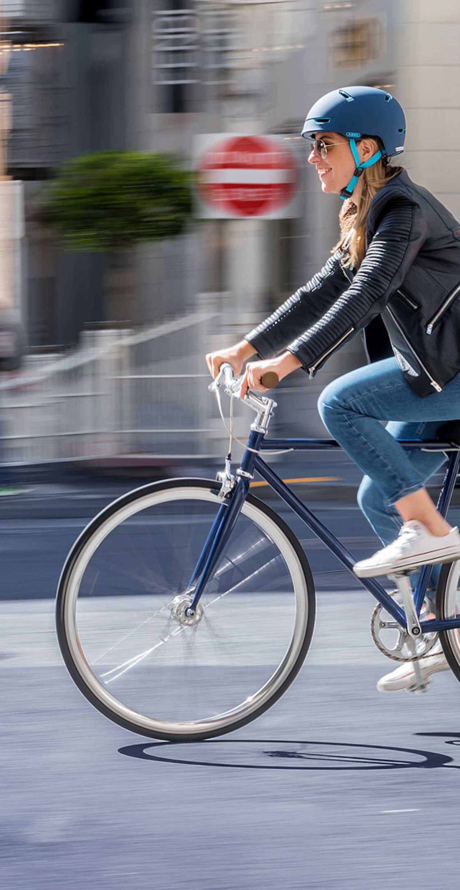 Abus girl in a bicycle with helmet vertical